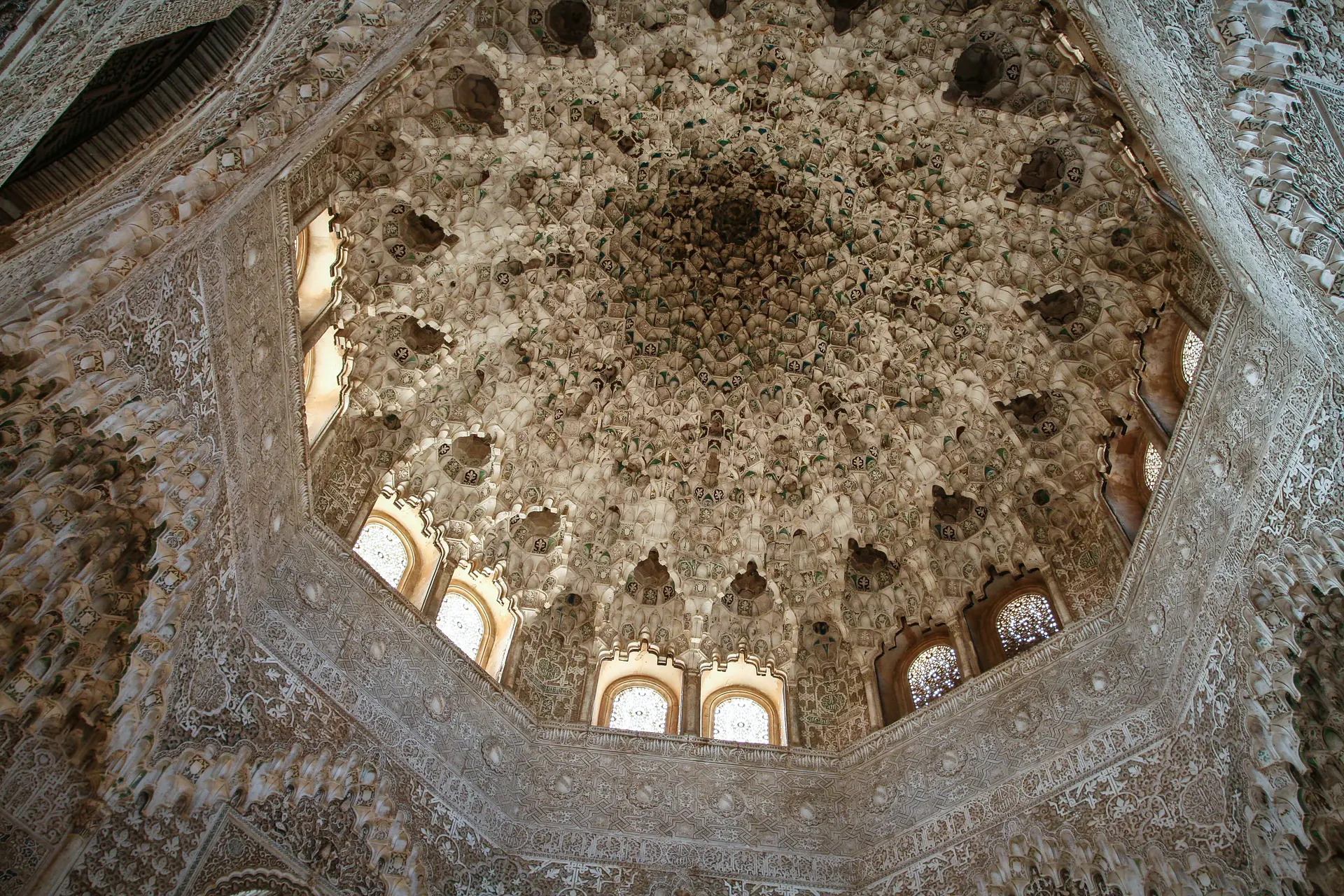 Intricate *muqarnas* dome ceiling with honeycomb stalactite structure at Alhambra palace