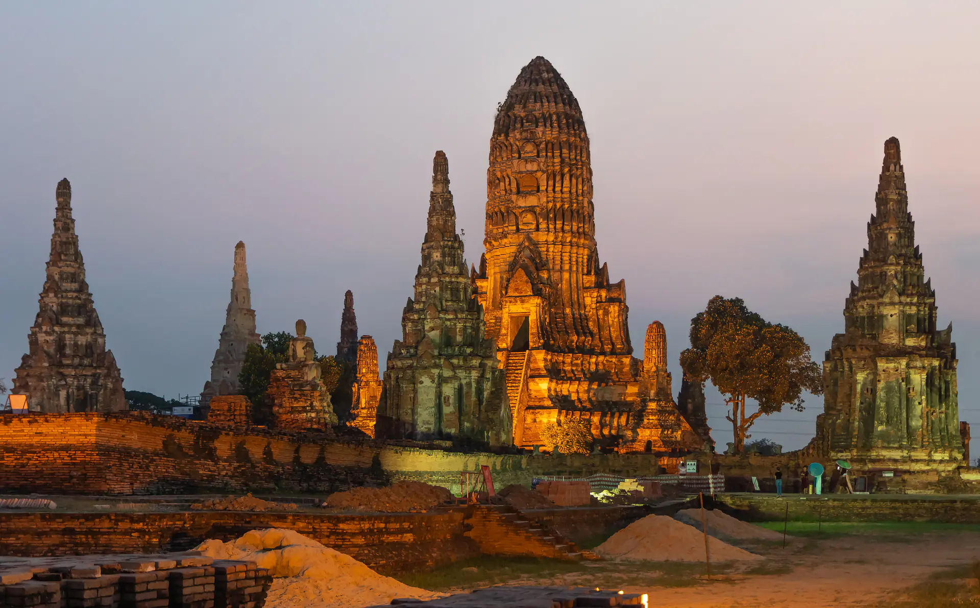 Panoramic view of Wat Chaiwatthanaram temple complex with central prang and satellite towers at sunset in Ayutthaya