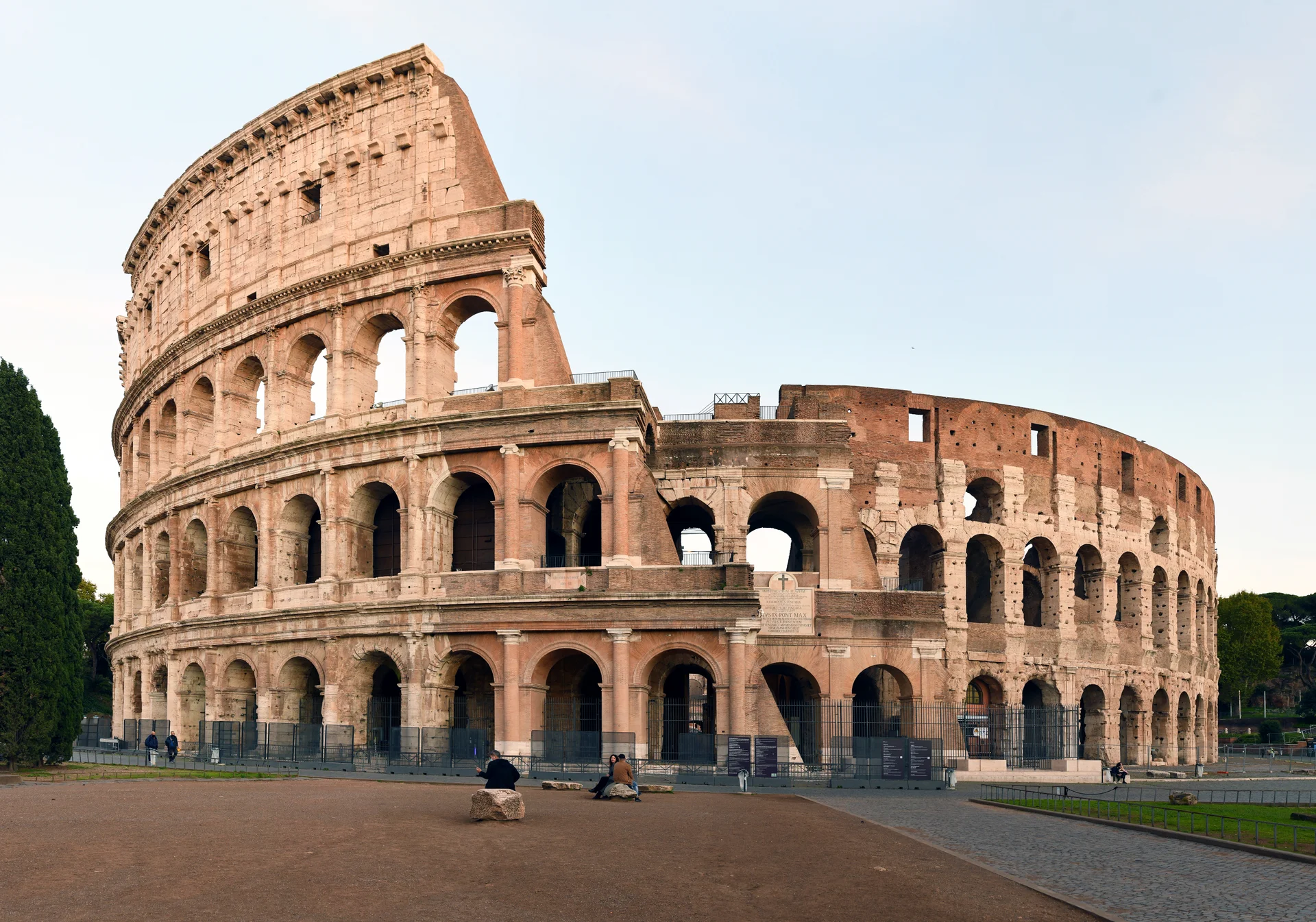 Vista en primer plano de la fachada del Coliseo mostrando los tres órdenes arquitectónicos distintos con columnas dóricas, jónicas y corintias en niveles sucesivos