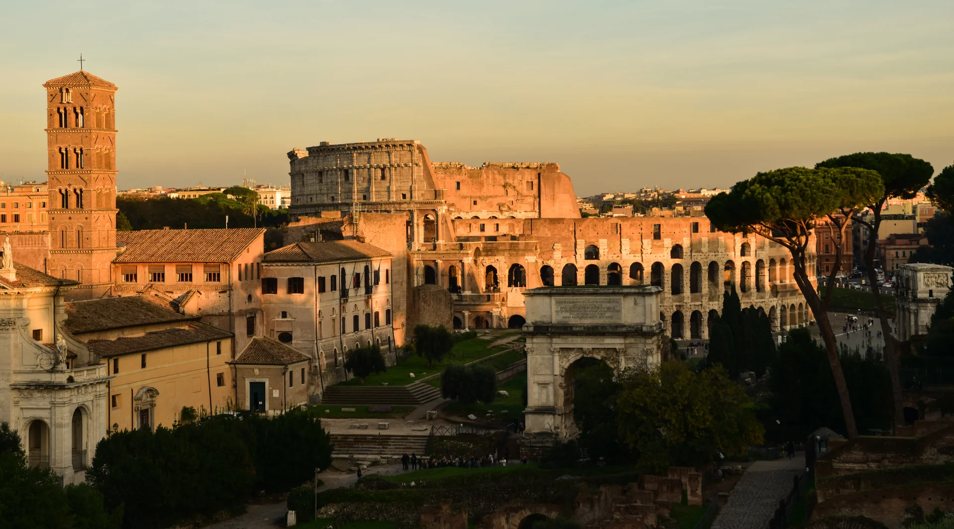 Vista panorámica desde el nivel superior del Coliseo mostrando la impresionante arquitectura de piedra del anfiteatro antiguo con el paisaje urbano de Roma extendiéndose a la distancia