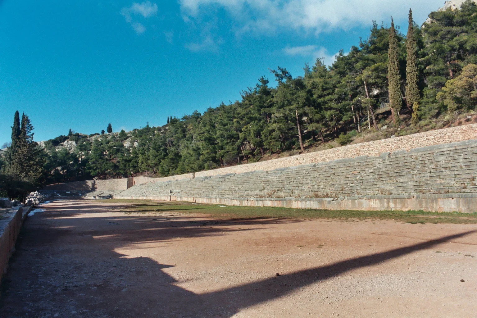 The ancient athletics stadium at Delphi showing the long track with stone seating areas built into the mountainside