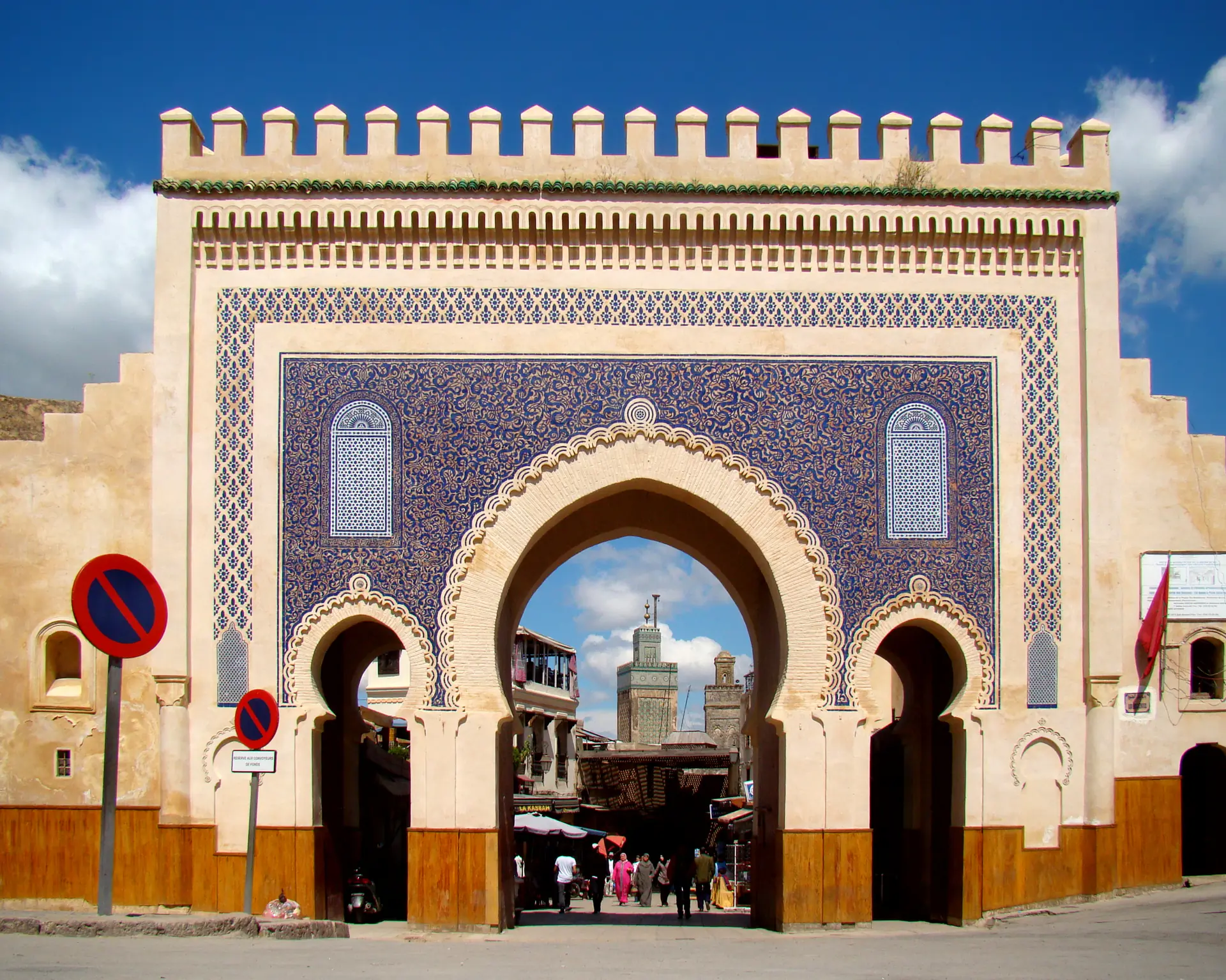 The iconic Bab Boujloud (Blue Gate) entrance to Fez medina displaying elaborate blue and green zellige tilework in traditional Moroccan architectural style