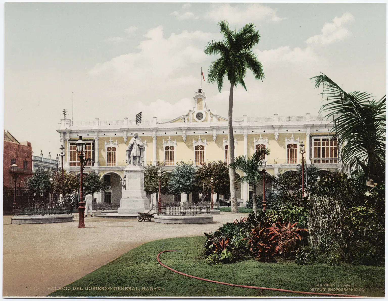 Coloridos autos americanos vintage de los años 50 estacionados a lo largo de una calle colonial en La Habana Vieja con edificios barrocos restaurados y palmeras al fondo