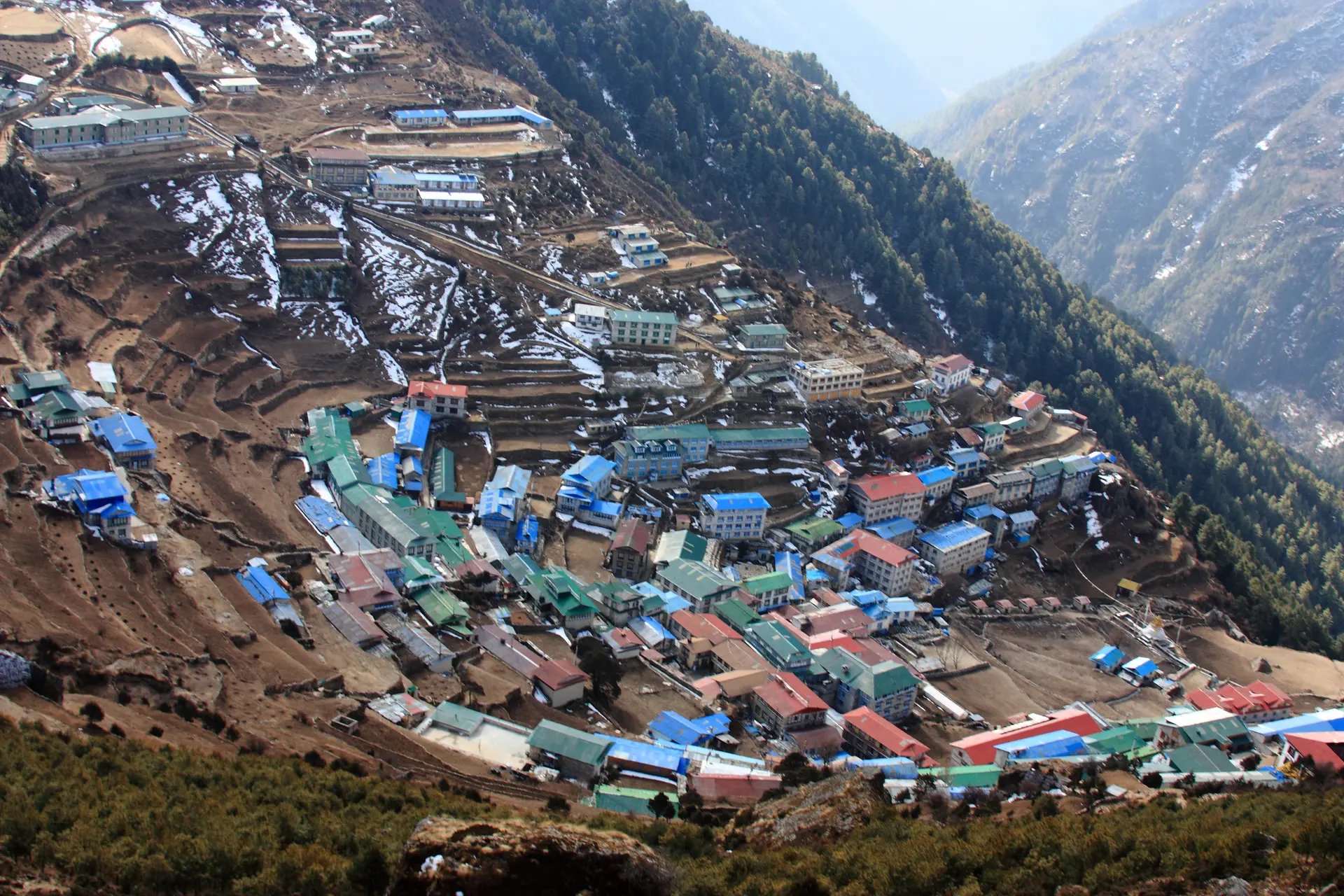 Aerial view of Namche Bazaar showing the terraced buildings of this Sherpa trading town nestled in a horseshoe-shaped mountain valley