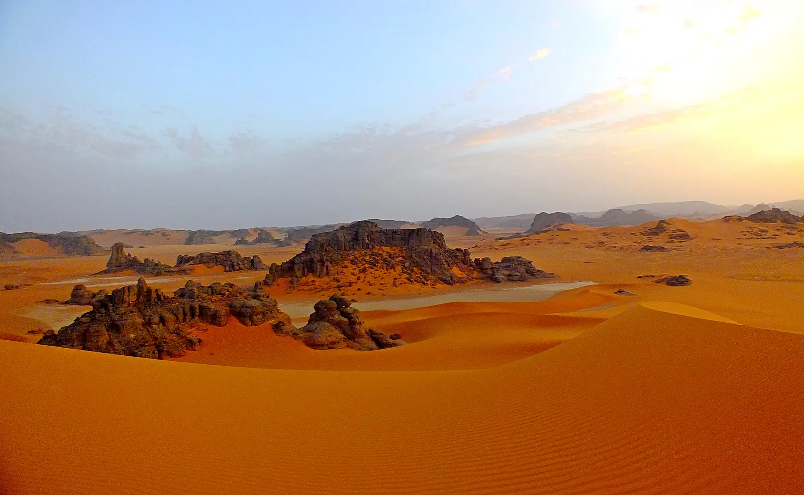 Terreno rocoso dramático y formaciones de arenisca en el Parque Nacional Tassili n'Ajjer mostrando el distintivo paisaje erosionado de la meseta sahariana